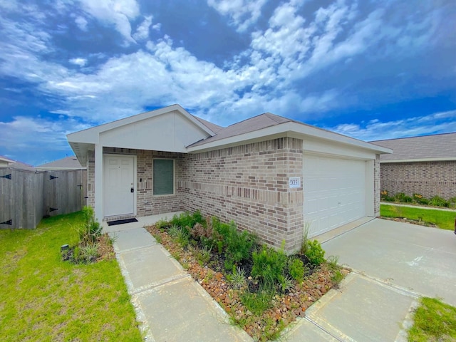 21015 Longeni Dr, New Caney, TX 77357 - ranch-style home with an attached garage, brick siding, and driveway