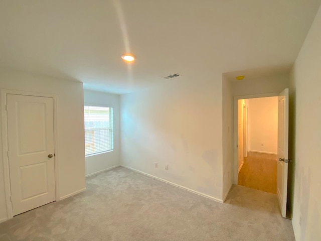 21015 Longeni Dr, New Caney, TX 77357 - unfurnished room featuring light colored carpet and baseboards
