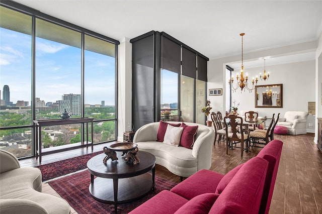 living room featuring a chandelier, a city view, dark wood finished floors, and a wall of windows