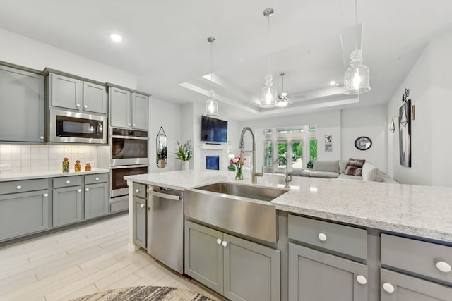 250 Peninsula Point Dr, Montgomery, TX 77356 - kitchen with gray cabinetry, a sink, appliances with stainless steel finishes, open floor plan, and recessed lighting