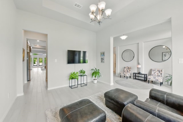 250 Peninsula Point Dr, Montgomery, TX 77356 - living room featuring a chandelier, baseboards, and wood finished floors