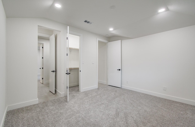 below grade area with baseboards, light colored carpet, recessed lighting, and visible vents