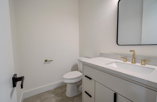 bathroom featuring toilet, baseboards, tile patterned flooring, and vanity