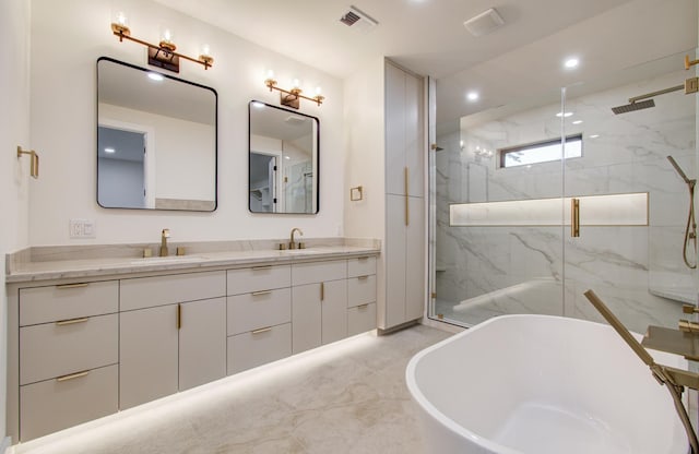 full bathroom featuring recessed lighting, visible vents, a marble finish shower, and a sink