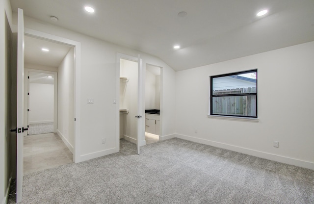 spare room featuring recessed lighting, baseboards, light colored carpet, and vaulted ceiling