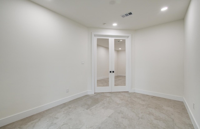 spare room with visible vents, recessed lighting, french doors, and light colored carpet