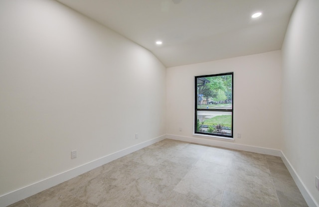 empty room with recessed lighting, baseboards, and lofted ceiling