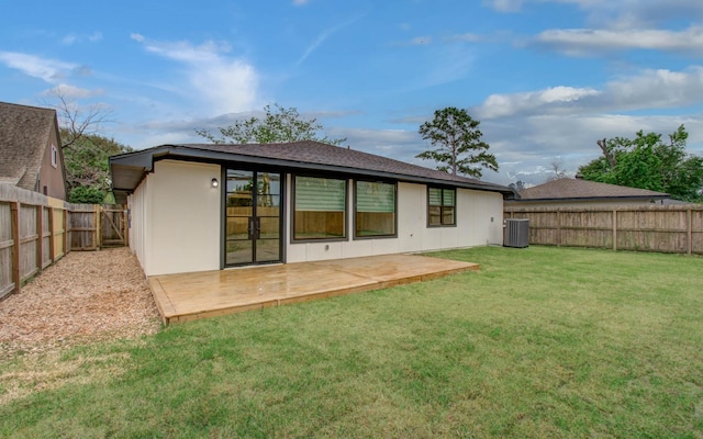 back of house featuring a shingled roof, central AC, a wooden deck, a fenced backyard, and a yard