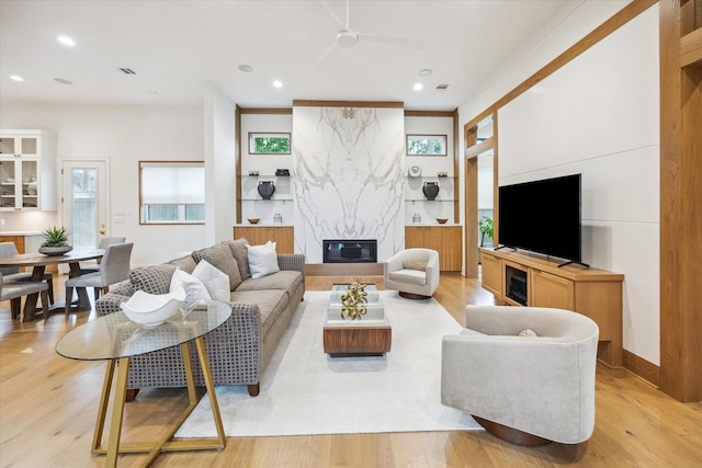 739 Azaleadell Dr, Houston, TX 77018 - living area featuring a high end fireplace, recessed lighting, light wood-style floors, and a healthy amount of sunlight