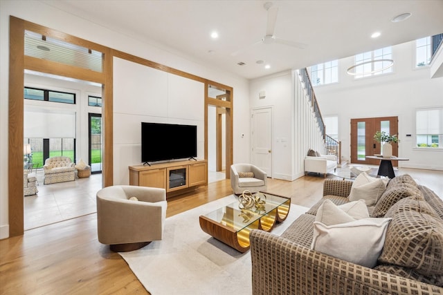 739 Azaleadell Dr, Houston, TX 77018 - living area with recessed lighting, light wood-style floors, ceiling fan, stairway, and a towering ceiling