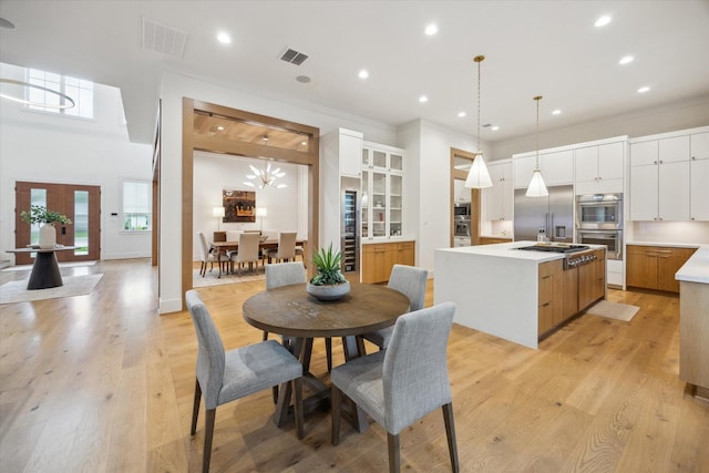 739 Azaleadell Dr, Houston, TX 77018 - dining space with visible vents, light wood-style floors, and crown molding