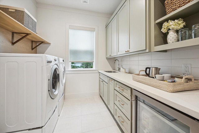 739 Azaleadell Dr, Houston, TX 77018 - clothes washing area featuring beverage cooler, light tile patterned floors, cabinet space, washing machine and dryer, and a sink