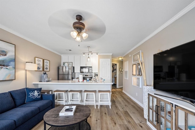 9520 Seawall Blvd Unit 254, Galveston, TX 77554 - living area with ceiling fan, light wood-style flooring, ornamental molding, and baseboards