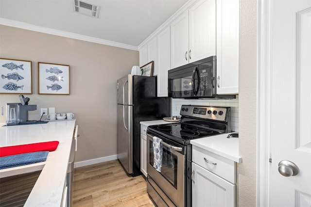 9520 Seawall Blvd Unit 254, Galveston, TX 77554 - kitchen featuring stainless steel appliances, crown molding, light wood finished floors, white cabinetry, and light countertops