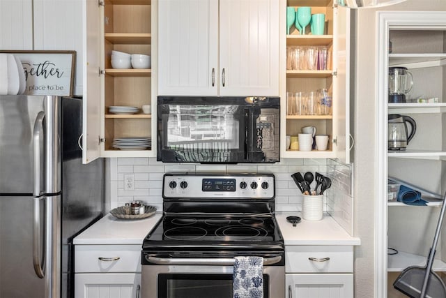 9520 Seawall Blvd Unit 254, Galveston, TX 77554 - kitchen with stainless steel appliances, backsplash, light countertops, and white cabinetry