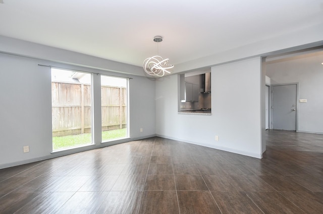 2918 Manila Ln, Houston, TX 77043 - unfurnished living room featuring a chandelier and baseboards