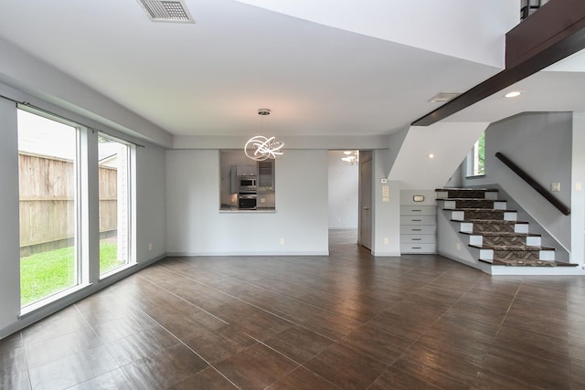 2918 Manila Ln, Houston, TX 77043 - unfurnished living room featuring a chandelier, stairway, and baseboards