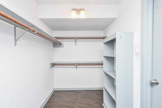 2918 Manila Ln, Houston, TX 77043 - spacious closet featuring dark tile patterned floors