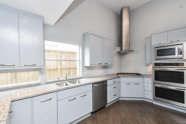 2918 Manila Ln, Houston, TX 77043 - kitchen with stainless steel appliances, a sink, wall chimney exhaust hood, light stone counters, and white cabinets