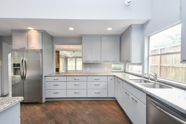 2918 Manila Ln, Houston, TX 77043 - kitchen featuring stainless steel appliances, a sink, gray cabinets, light stone counters, and recessed lighting
