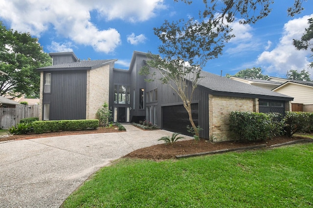 2918 Manila Ln, Houston, TX 77043 - view of side of property with concrete driveway, a garage, fence, and brick siding