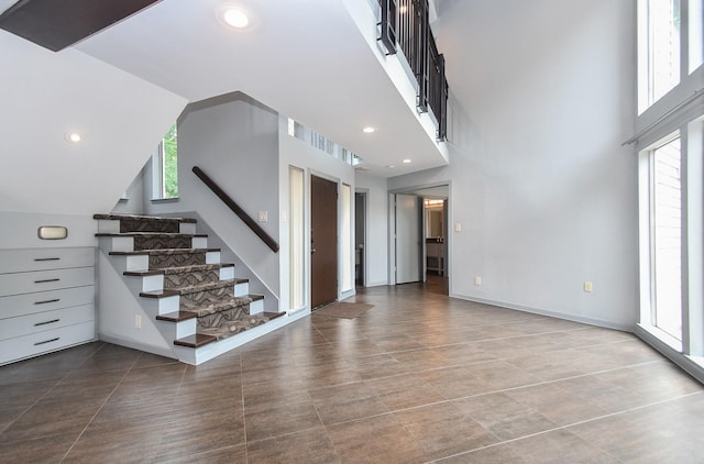 2918 Manila Ln, Houston, TX 77043 - unfurnished living room featuring stairway, healthy amount of natural light, and recessed lighting
