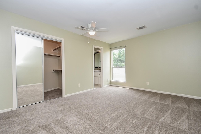 2918 Manila Ln, Houston, TX 77043 - unfurnished bedroom with carpet floors, baseboards, a walk in closet, connected bathroom, and a closet