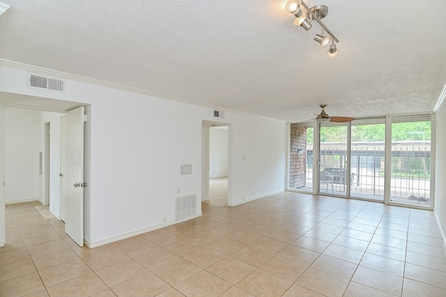 spare room with ornamental molding and visible vents