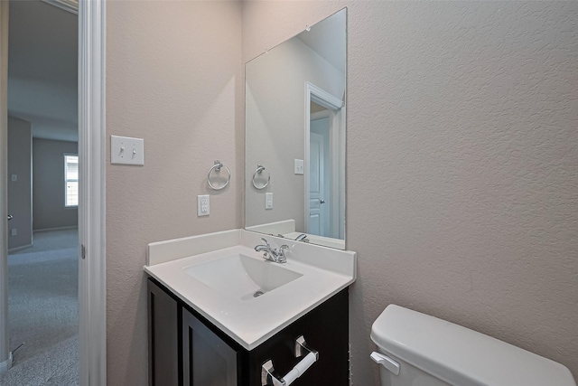 2402 Ivory Ct, Texas City, TX 77591 - bathroom with a textured wall, toilet, and vanity