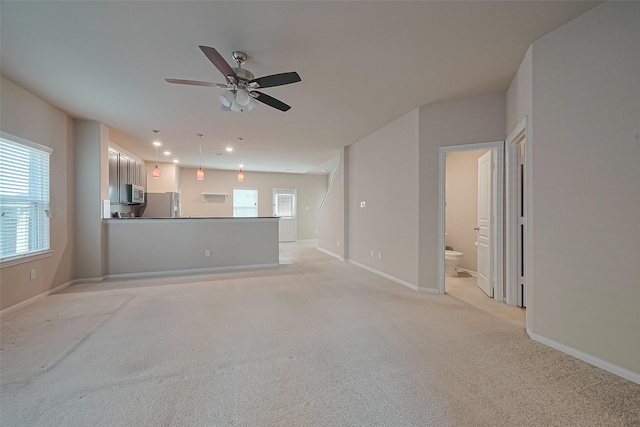 2402 Ivory Ct, Texas City, TX 77591 - unfurnished living room with a ceiling fan, light carpet, baseboards, and recessed lighting