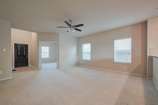 2402 Ivory Ct, Texas City, TX 77591 - unfurnished living room with plenty of natural light, light carpet, ceiling fan, and visible vents