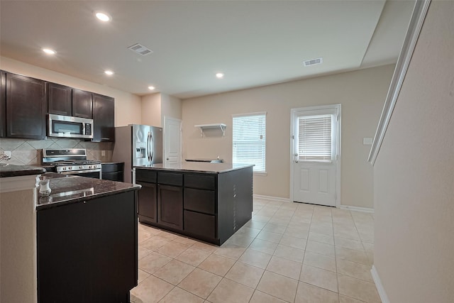 2402 Ivory Ct, Texas City, TX 77591 - kitchen featuring light tile patterned flooring, visible vents, stainless steel appliances, and backsplash