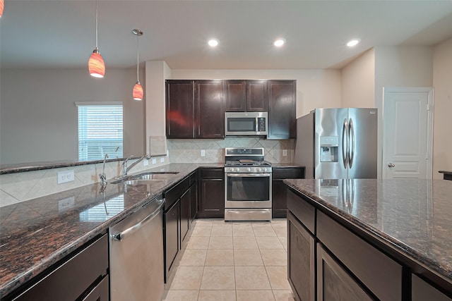 2402 Ivory Ct, Texas City, TX 77591 - kitchen with light tile patterned floors, stainless steel appliances, dark stone countertops, backsplash, and a sink