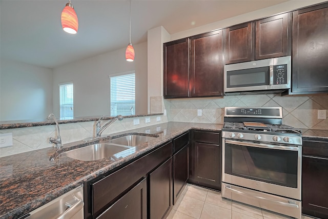 2402 Ivory Ct, Texas City, TX 77591 - kitchen with a sink, dark stone countertops, stainless steel appliances, decorative backsplash, and dark brown cabinets