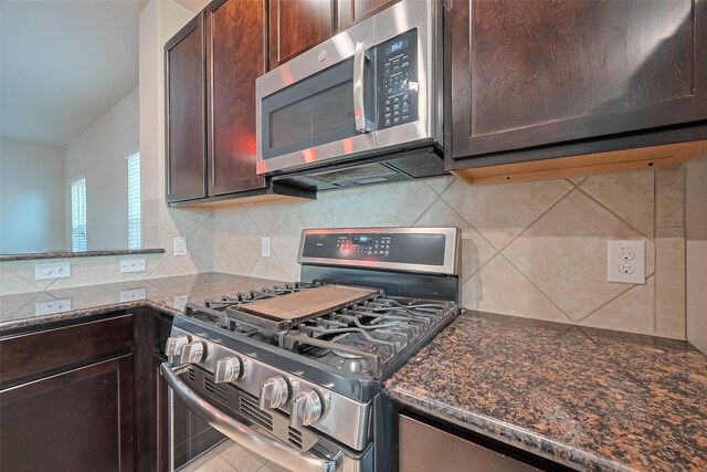 2402 Ivory Ct, Texas City, TX 77591 - kitchen with dark brown cabinets, decorative backsplash, dark stone countertops, and stainless steel appliances