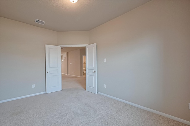 2402 Ivory Ct, Texas City, TX 77591 - unfurnished room with light carpet, baseboards, and visible vents