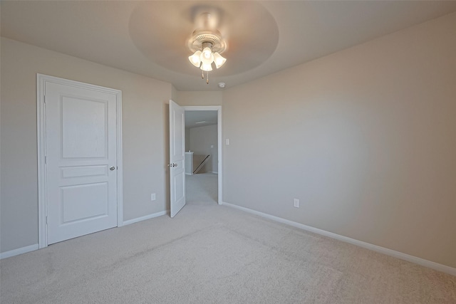 2402 Ivory Ct, Texas City, TX 77591 - unfurnished bedroom featuring baseboards, ceiling fan, and light carpet
