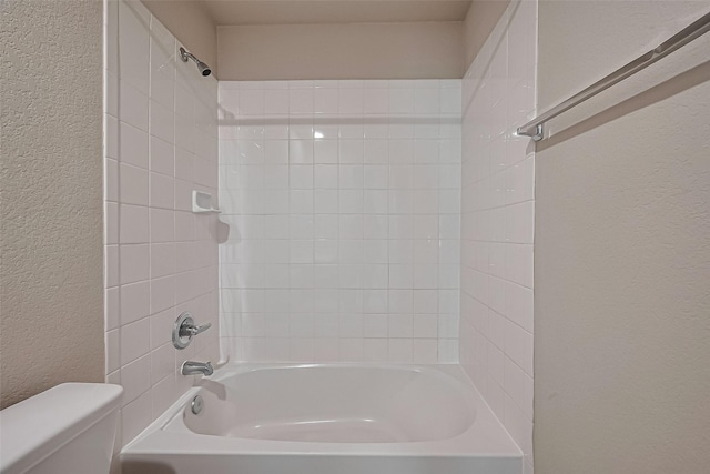 2402 Ivory Ct, Texas City, TX 77591 - bathroom with a textured wall, toilet, and shower / bath combination