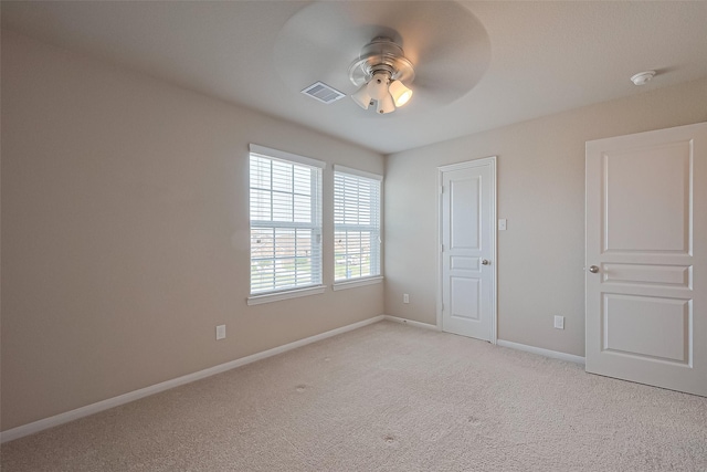 2402 Ivory Ct, Texas City, TX 77591 - unfurnished bedroom with light carpet, baseboards, visible vents, and ceiling fan