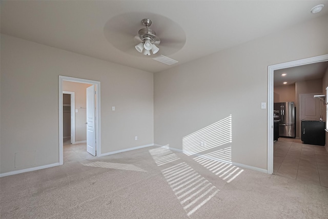 2402 Ivory Ct, Texas City, TX 77591 - unfurnished room with light colored carpet, visible vents, baseboards, and a ceiling fan
