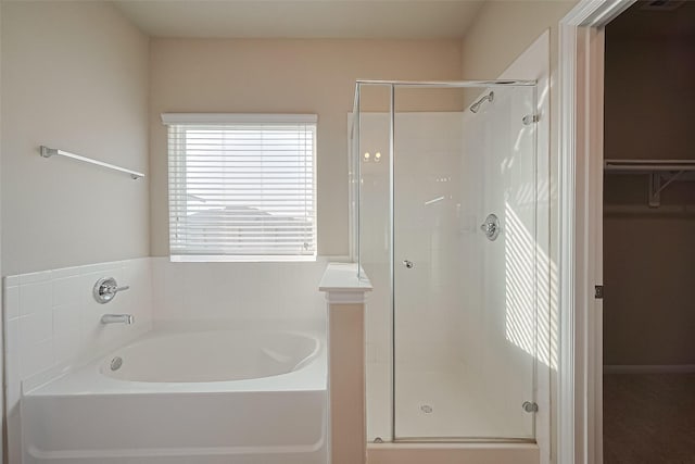 2402 Ivory Ct, Texas City, TX 77591 - full bathroom featuring a walk in closet, a stall shower, and a garden tub