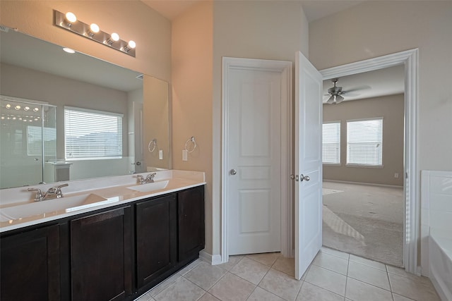 2402 Ivory Ct, Texas City, TX 77591 - bathroom with double vanity, ceiling fan, a sink, and tile patterned floors