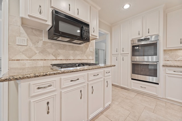 3708 Masters Ct, League City, TX 77573 - kitchen with stainless steel appliances, white cabinetry, tasteful backsplash, light stone counters, and ornamental molding