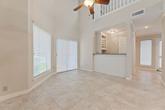 3708 Masters Ct, League City, TX 77573 - unfurnished living room featuring a ceiling fan, baseboards, tile patterned flooring, a towering ceiling, and crown molding