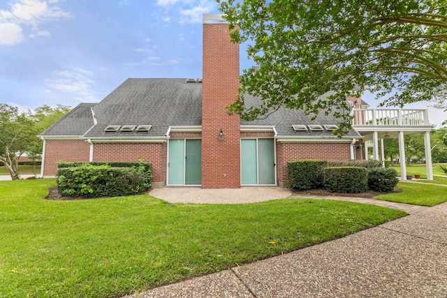3708 Masters Ct, League City, TX 77573 - view of front facade featuring brick siding, a chimney, a front yard, and a shingled roof