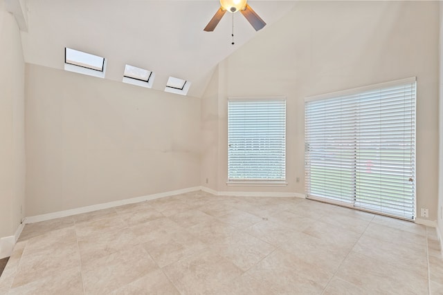 3708 Masters Ct, League City, TX 77573 - empty room with high vaulted ceiling, a skylight, a ceiling fan, light tile patterned flooring, and baseboards