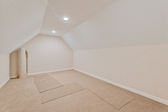 3708 Masters Ct, League City, TX 77573 - additional living space with vaulted ceiling, light colored carpet, baseboards, recessed lighting, and a textured ceiling