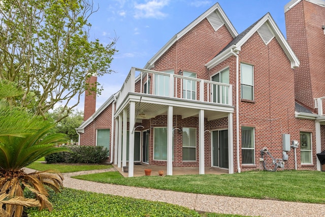 3708 Masters Ct, League City, TX 77573 - back of house with a balcony, brick siding, a lawn, and a patio