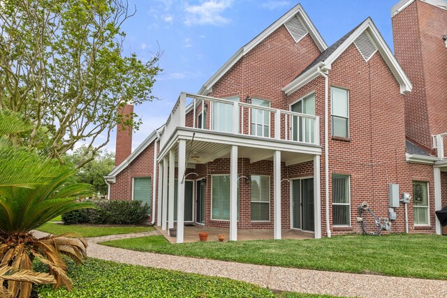 3708 Masters Ct, League City, TX 77573 - rear view of house with a balcony, brick siding, a yard, a chimney, and a patio