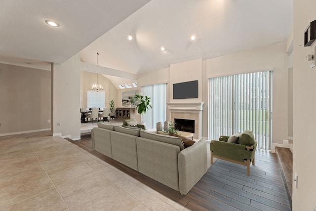 3708 Masters Ct, League City, TX 77573 - living room with a chandelier, a fireplace, baseboards, and high vaulted ceiling